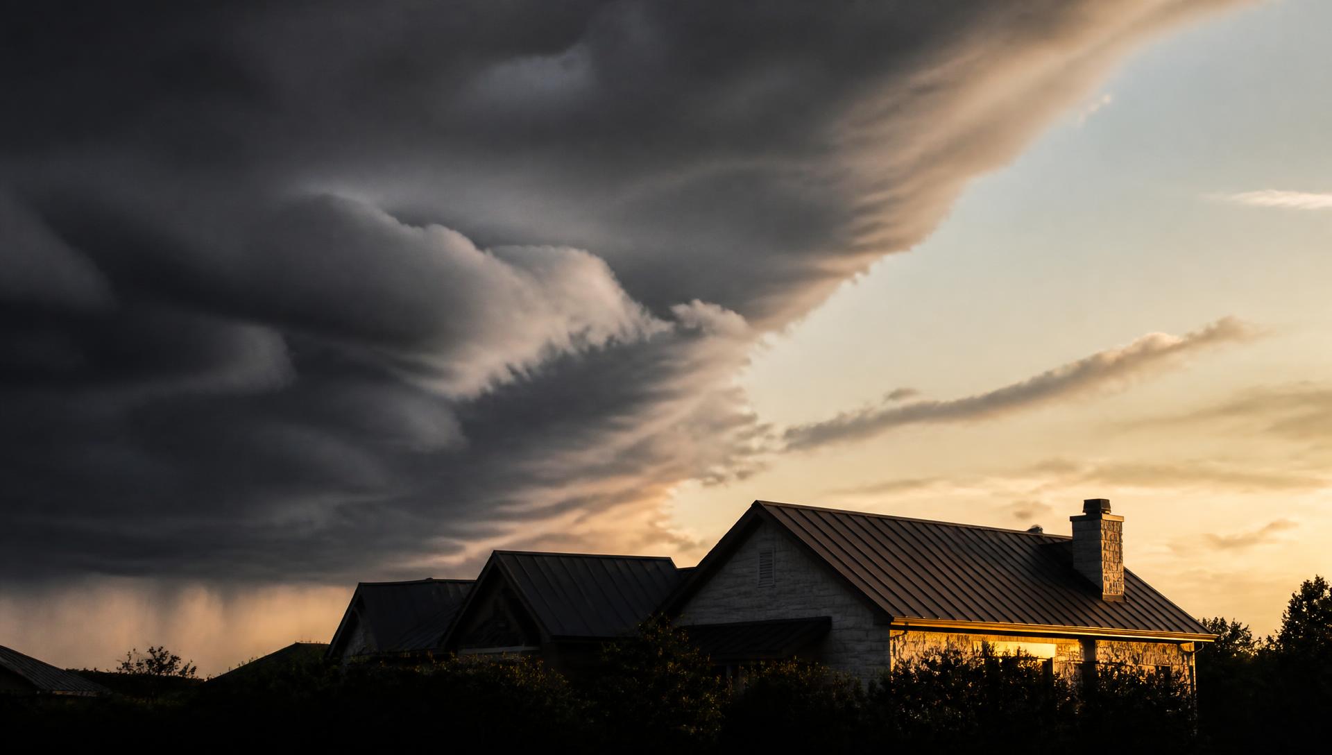 SummitShield Roofing website hero, a storm horizon over a roofline